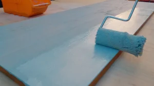 Painting Acacia hardwood panel with 2 to 3 layers of primer, to prepare it for painting.